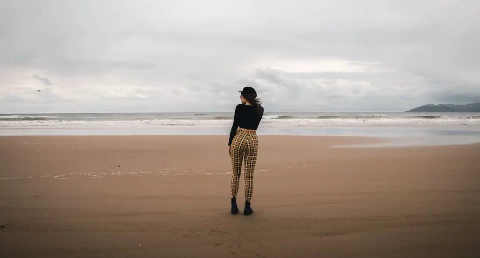 girl standing wearing beach outfit