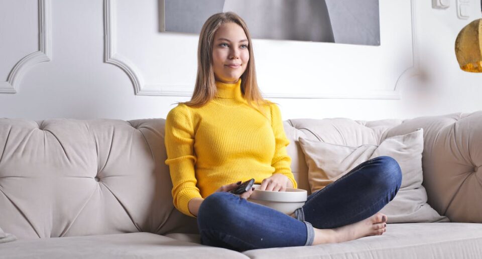 woman sitting on couch alone