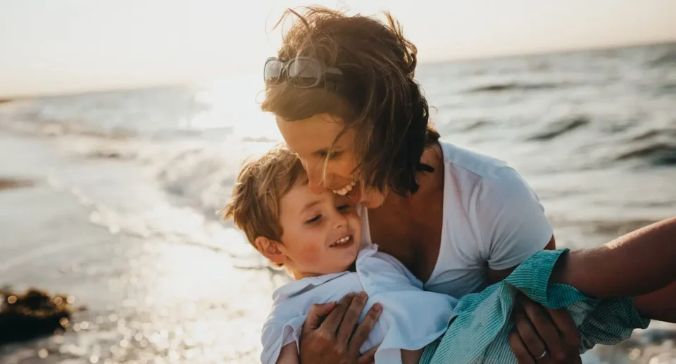 single parent travel with a kid on a beach