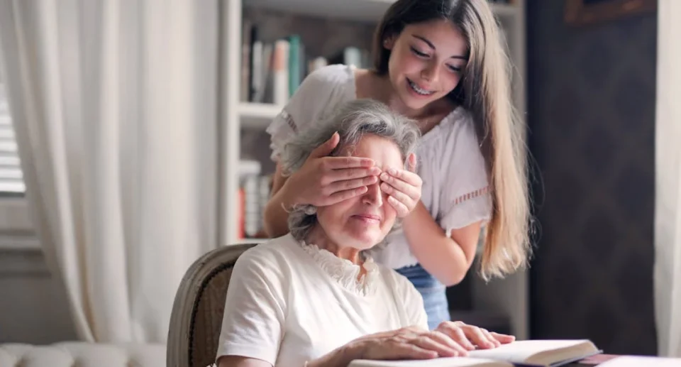 a girl surprising her grandparent